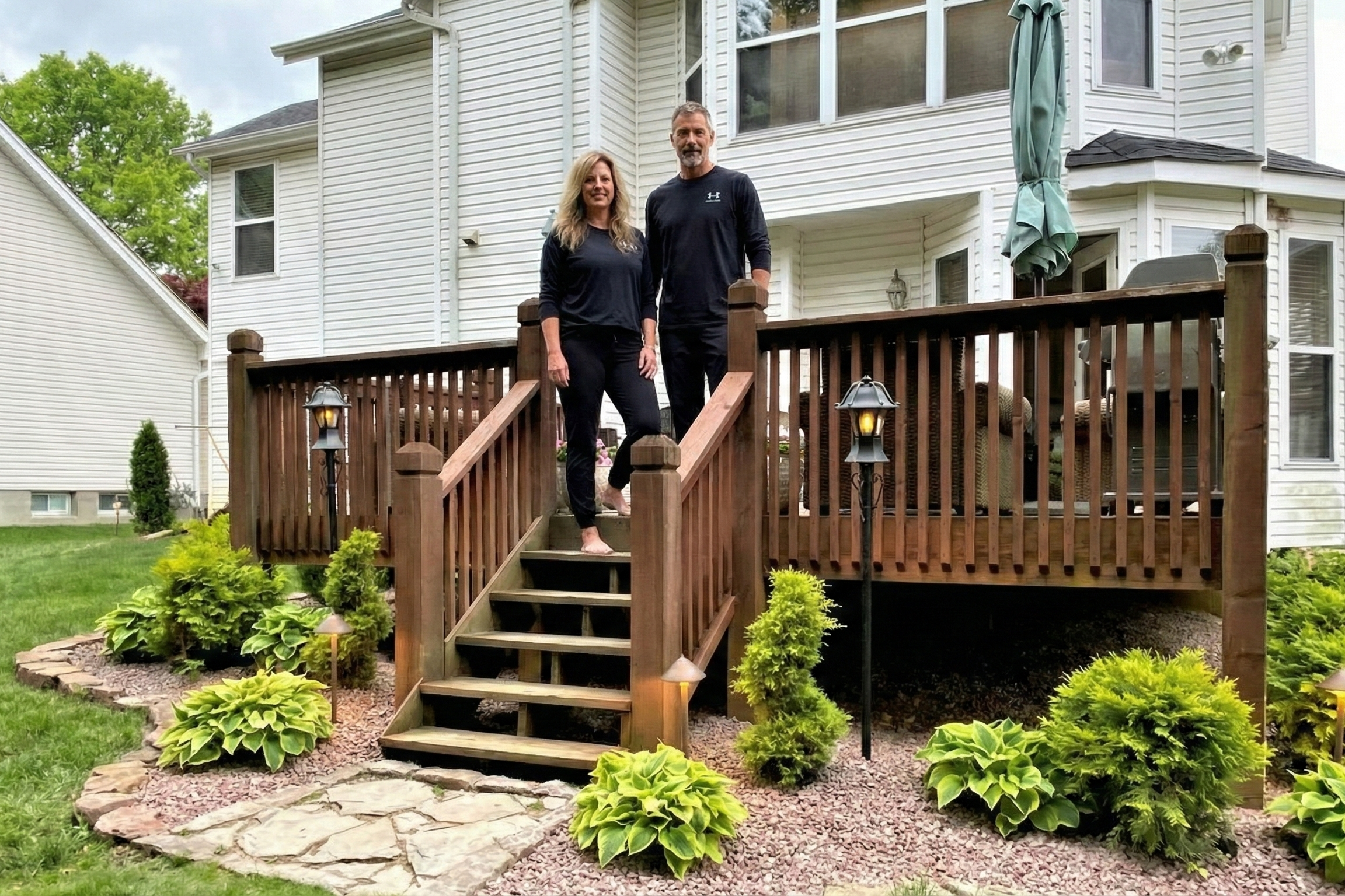 Casual portrait of Joey Montes and Heather Killebrew posing on the back deck of their home at Grover Ridge.