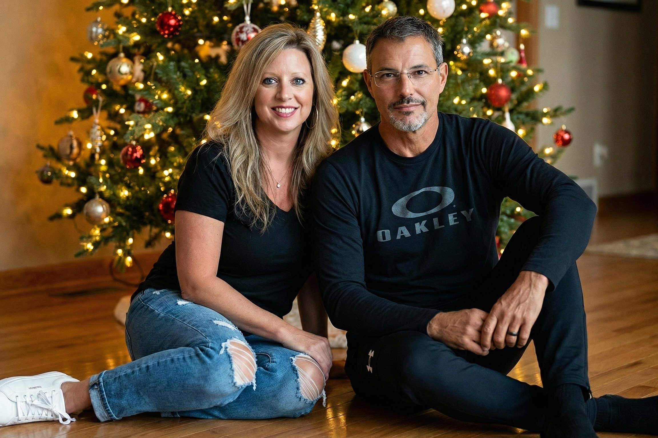 Casual holiday portrait of Heather in ripped jeans and black tee sitting with Joey Montes.