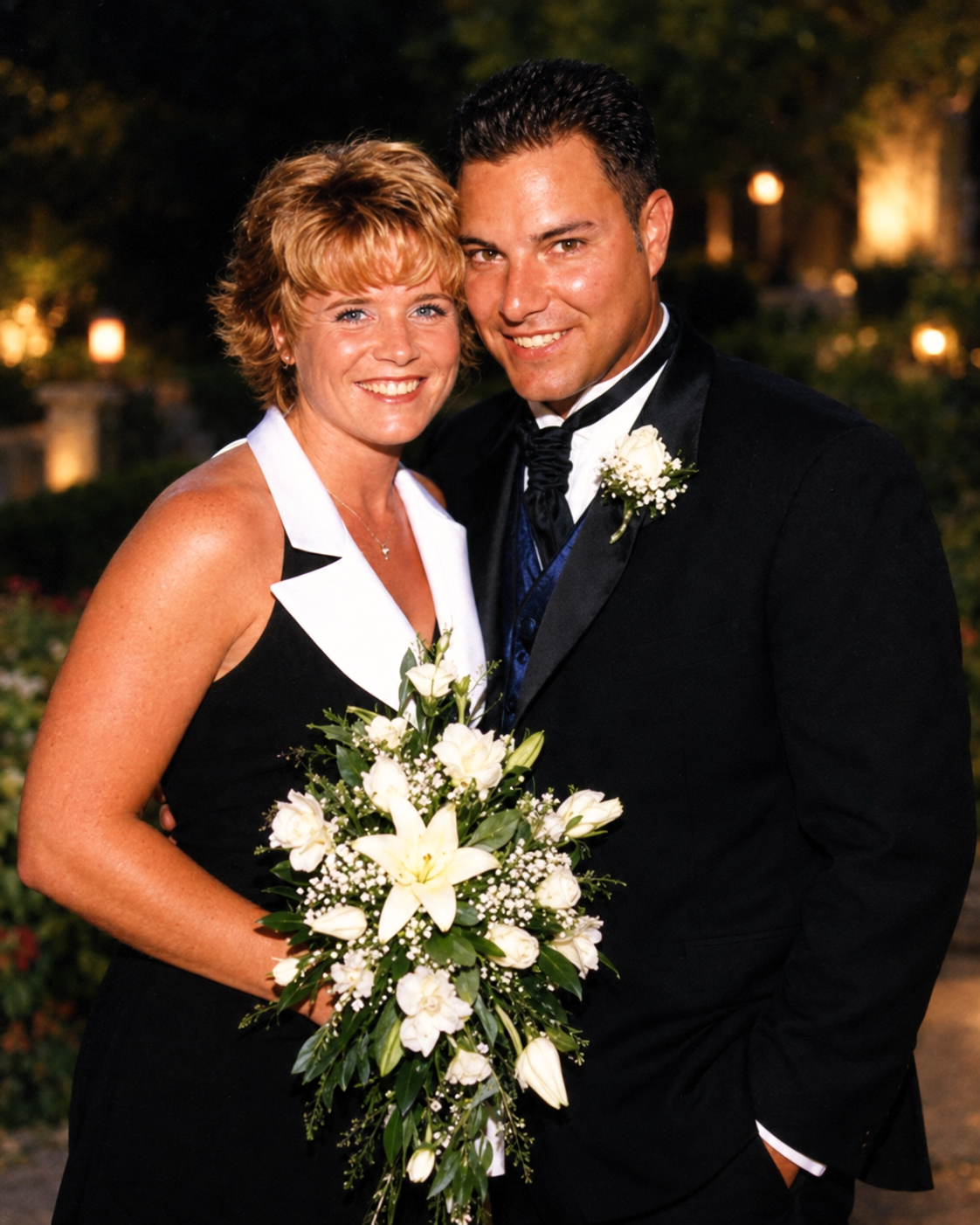 Dawne and Joey smiling together in formal attire on July 27, 2001, with a bouquet of white flowers.