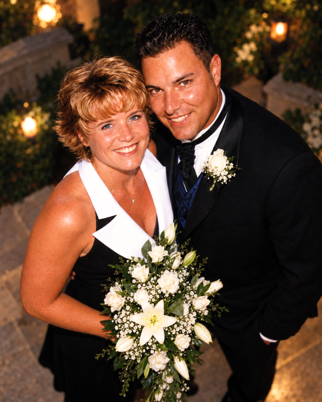 An overhead portrait of Dawne and Joey smiling together with white flowers on July 27, 2001.