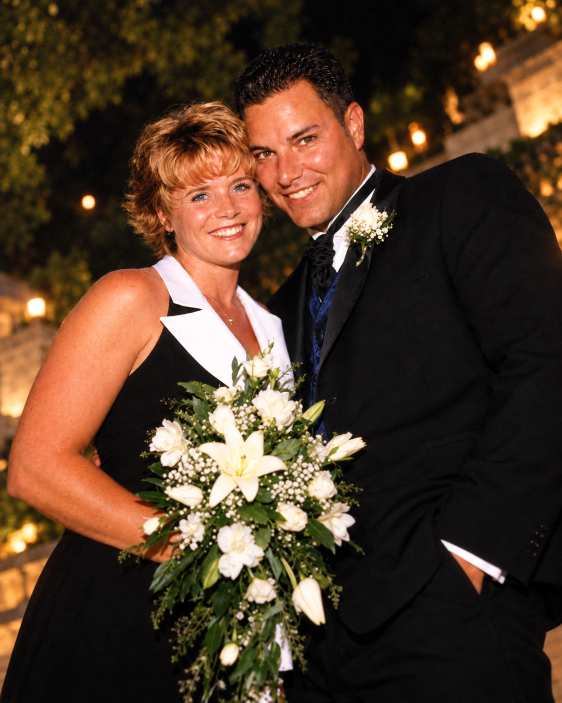 Dawne and Joey standing close together outdoors during an evening celebration in July 2001.