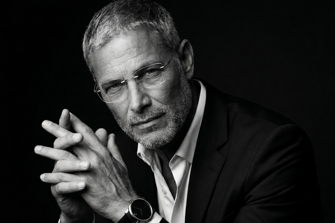 A dignified close-up portrait of a 57-year-old man reflecting on the passage of time.