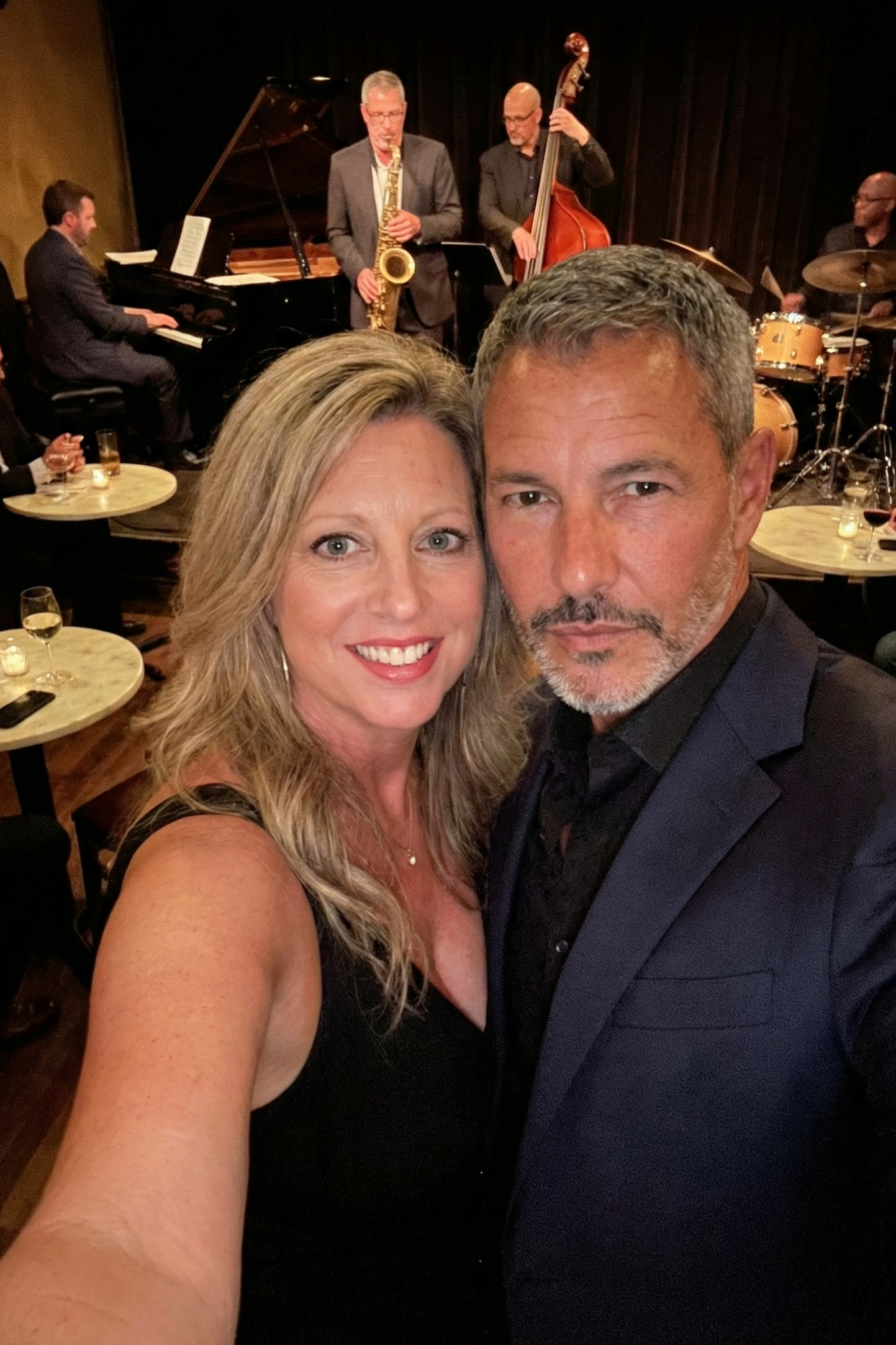 Selfie of Heather Killebrew and Joey Montes at a jazz club with a live band performing in the background.