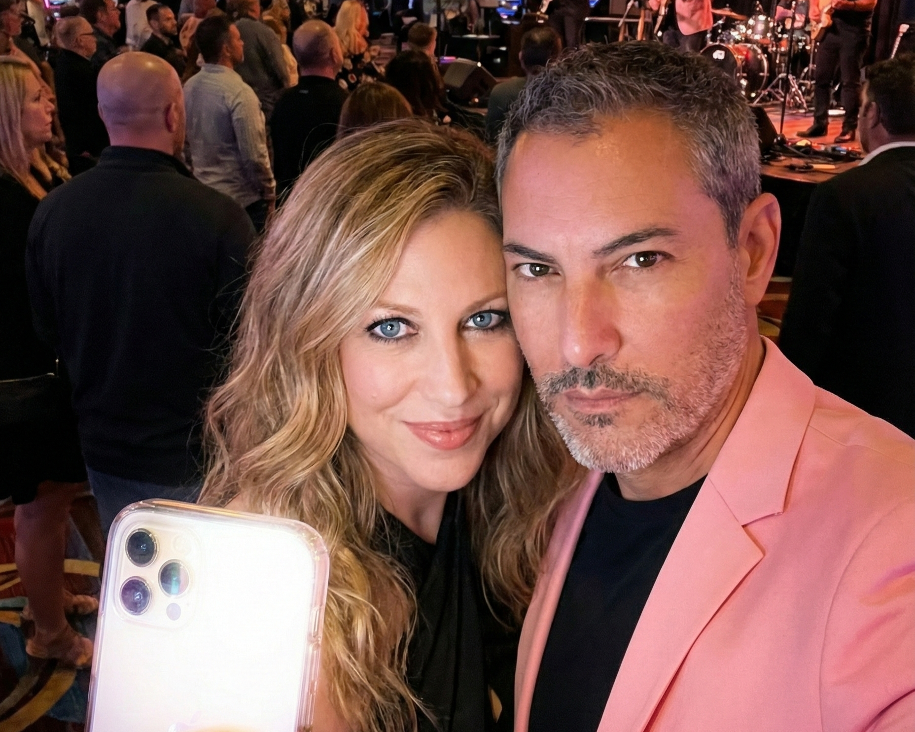Close-up selfie of Heather and Joey Montes in a busy casino.