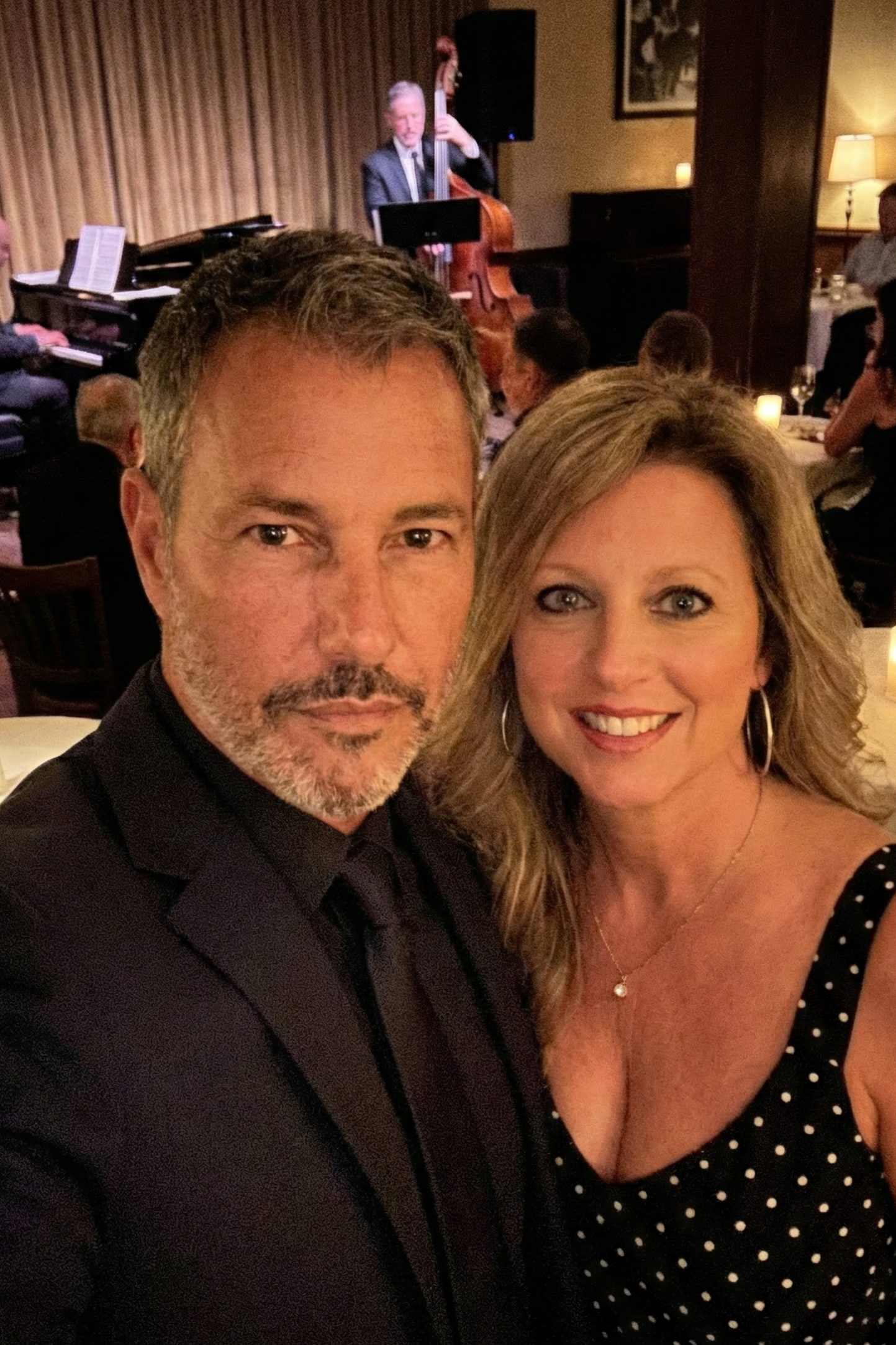 Selfie of Joey Montes in a dark suit and Heather Killebrew wearing a polka dot dress at a candlelight jazz dinner.