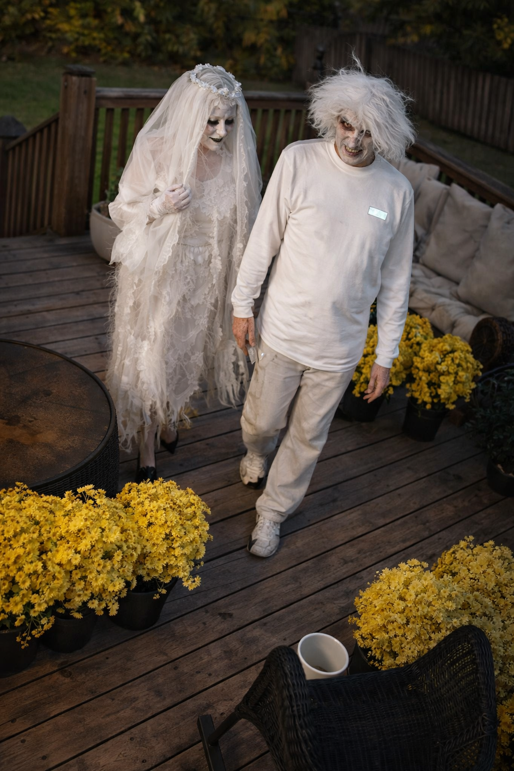 Joey Montes and Heather Killebrew dressed as a ghostly bride and groom walking on a deck in Wildwood, MO.