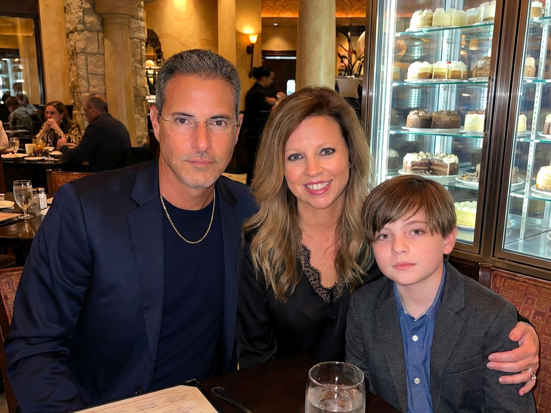 Joey Montes, Heather Killebrew, and a young boy dressed up for dinner at The Cheesecake Factory in Chesterfield, MO.