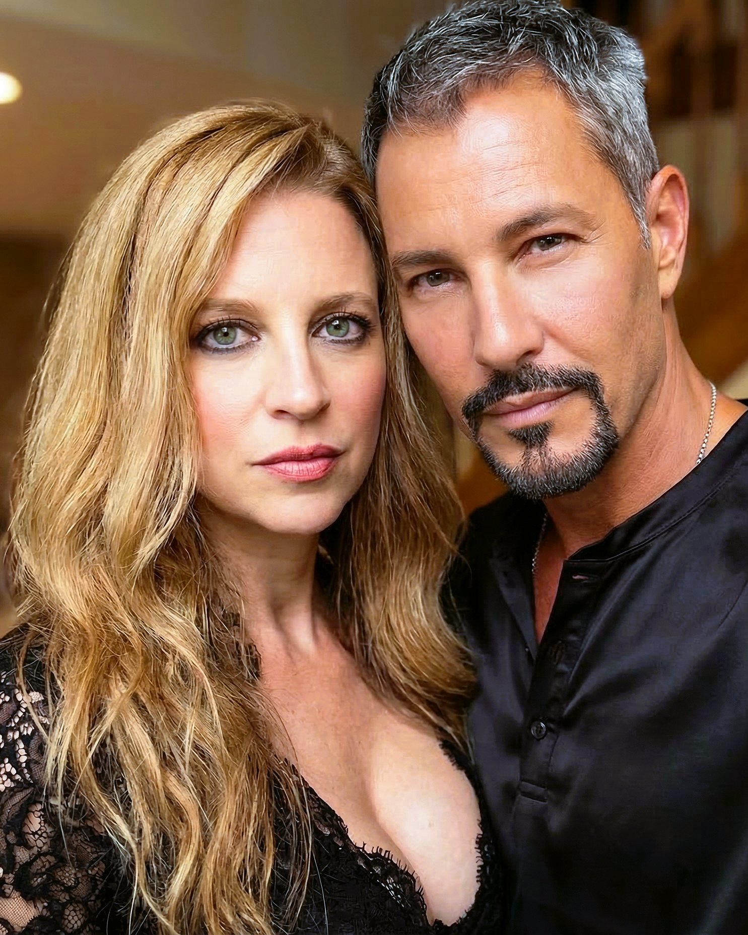 A close-up portrait of Heather smiling gently, wearing a black lace top at home in Wildwood in 2022.