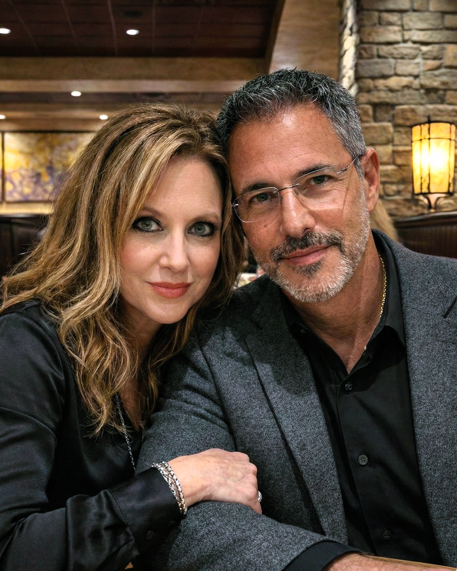 Portrait of Heather Killebrew leaning her head on Joey Montes' temple during dinner in Chesterfield, MO, 2024.