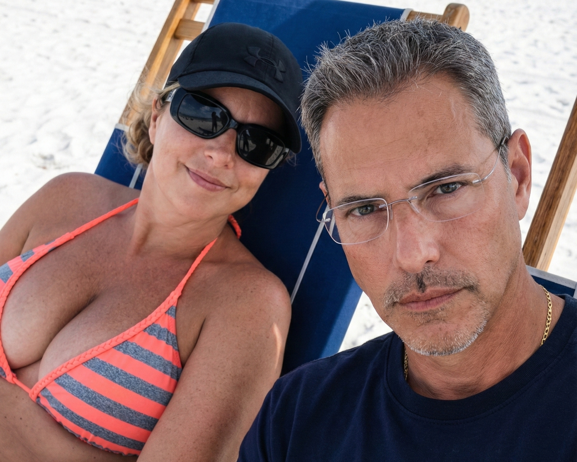 Selfie of Joey Montes looking serious and Heather Killebrew smiling in a beach chair in Destin, Florida in 2018.
