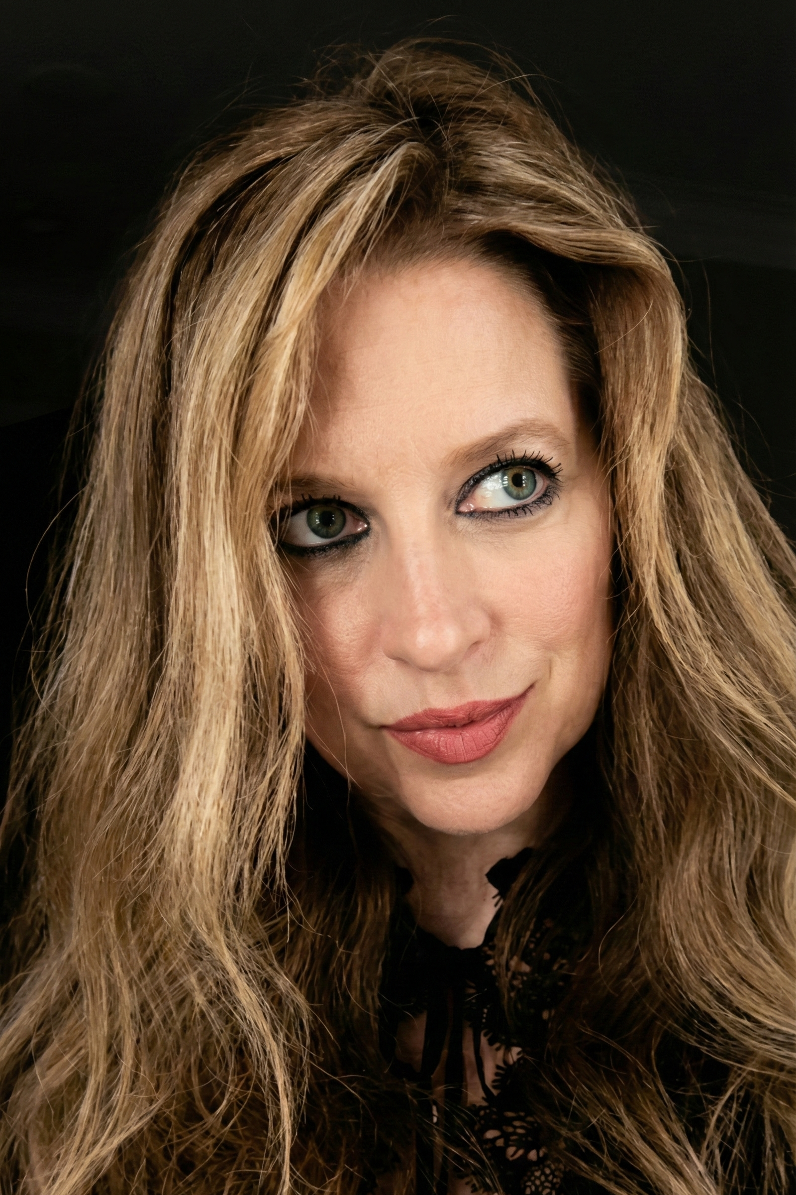 Selfie of Heather Killebrew looking to the side in a black lace top in Dresden, TN.