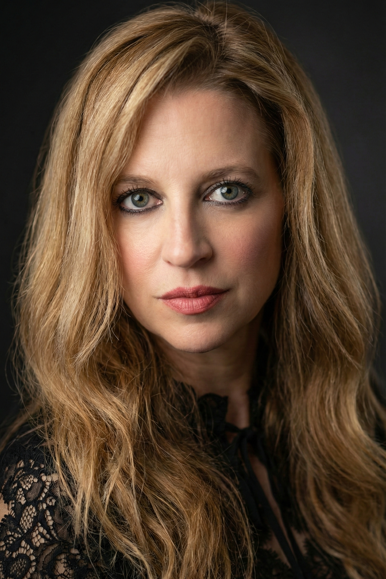 Serious portrait selfie of Heather Killebrew with dramatic eye makeup.