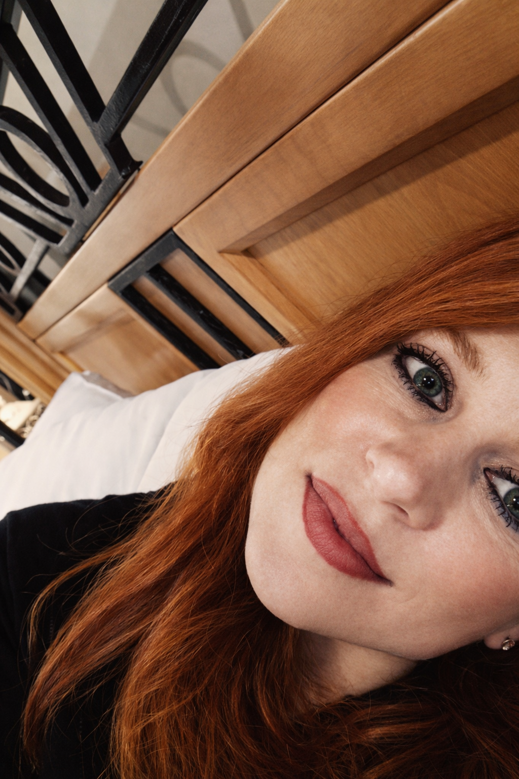 Close-up selfie of Heather Killebrew relaxing against a headboard in Dresden, TN.