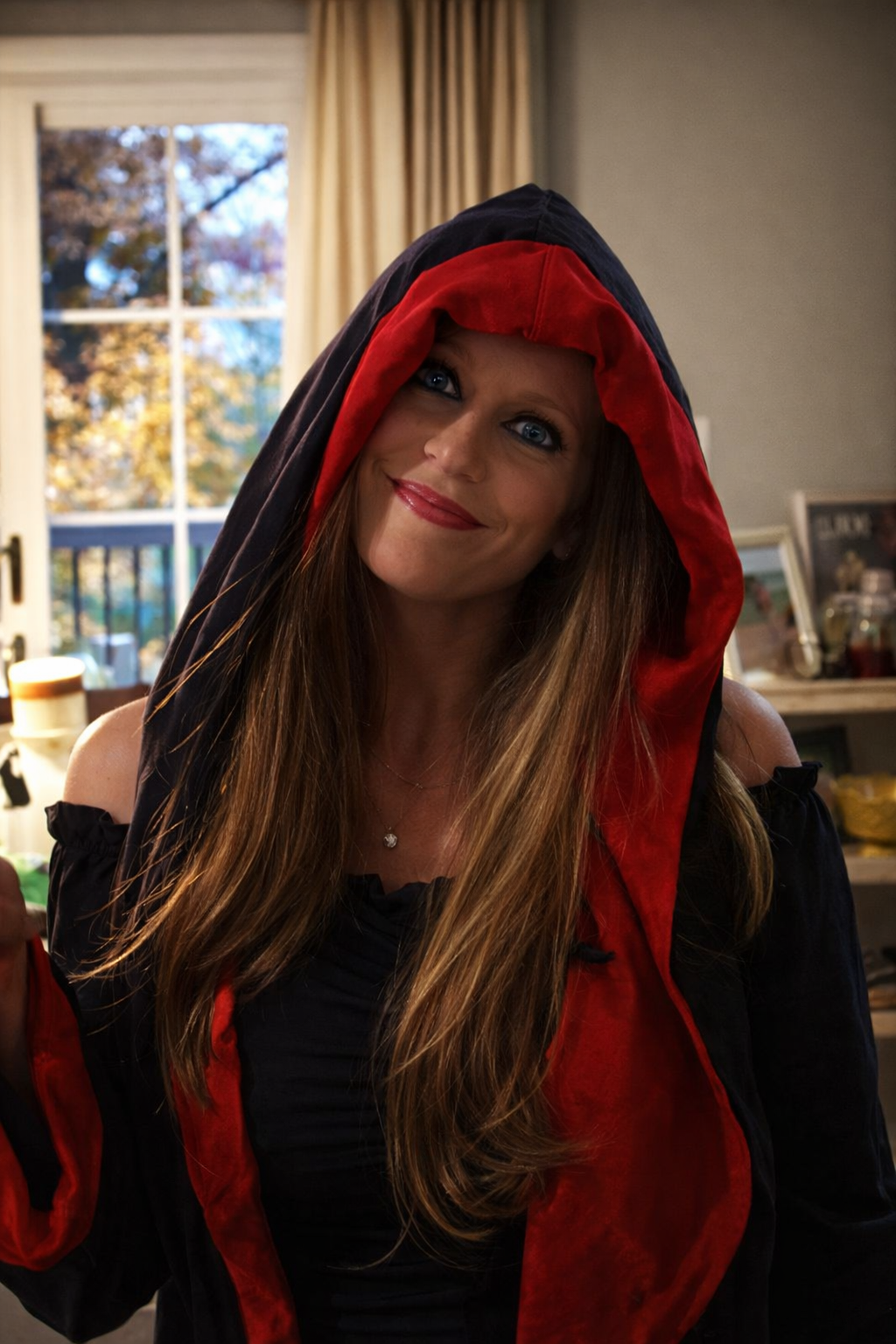 Portrait of Heather Killebrew wearing a black and red hooded Halloween costume in Wentzville, MO, 2018.