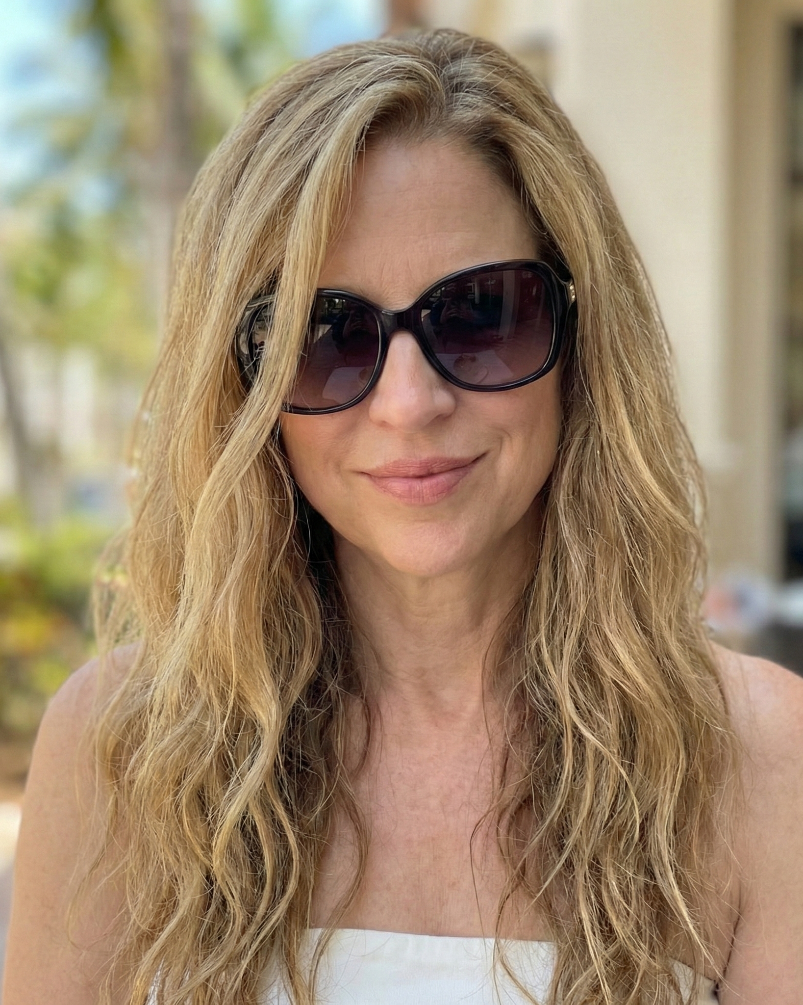 Close-up portrait of Heather Killebrew wearing sunglasses on a sunny day in Wildwood, MO.