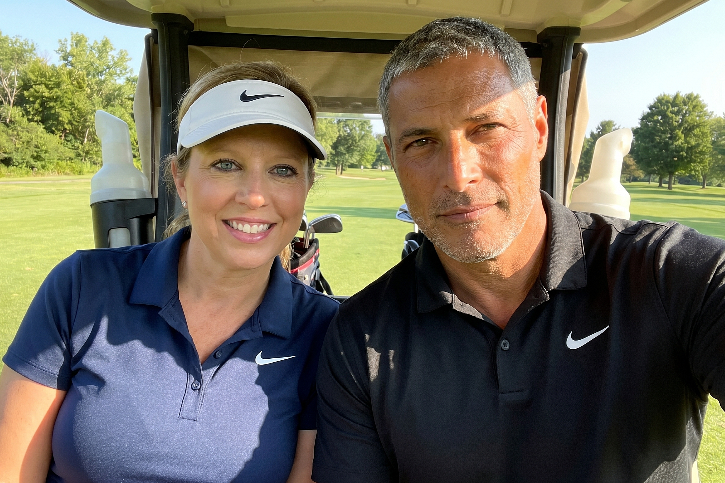 Heather and her companion sharing a smile in a golf cart during a sunny May 2023 outing.