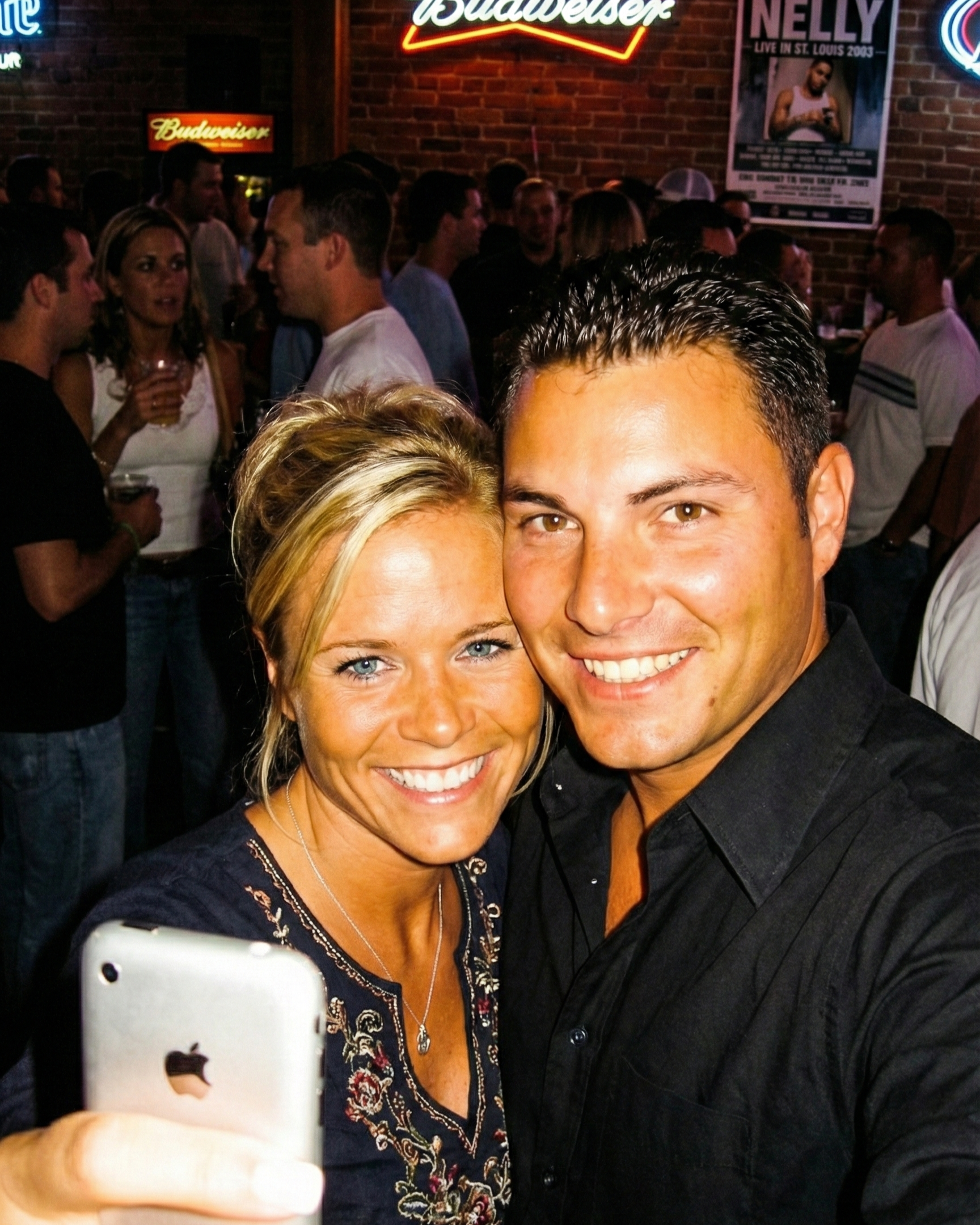 Close up selfie of Joey and Dawne smiling together in a crowded St. Louis bar.